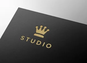 Premium luxury gold embossed logo mockup on black paper featuring a minimalist crown logo.
