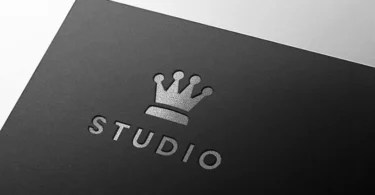 Premium silver embossed logo mockup on luxury dark paper with metallic foil texture.